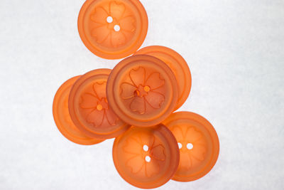 Directly above shot of orange juice against white background