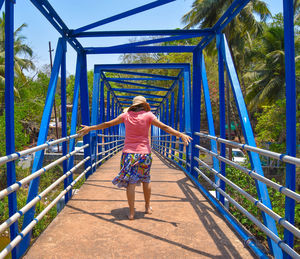 Full length of woman standing on footbridge