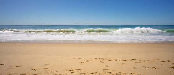 Scenic view of sea against clear blue sky