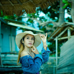 Portrait of a smiling girl holding hat