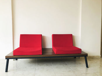 Empty chair against wall at home