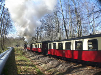 Train on railroad track against sky