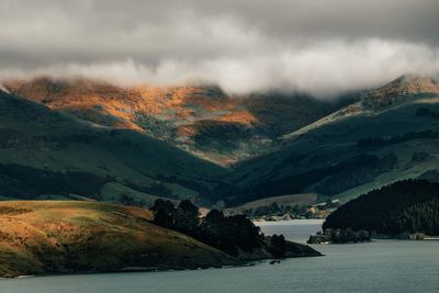 Scenic view of lake and mountains against sky