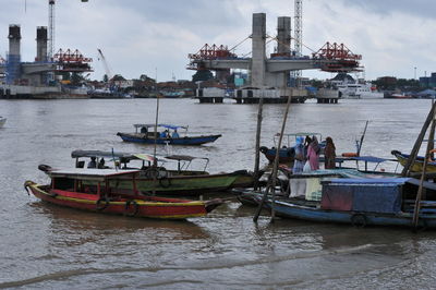 Fishing boats in sea at harbor