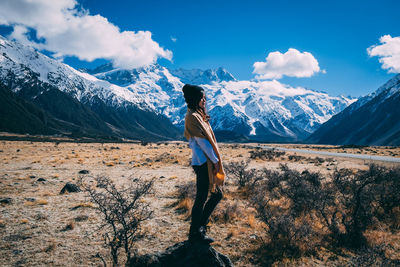 Man standing on mountain against sky