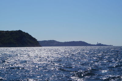 Scenic view of sea against clear blue sky