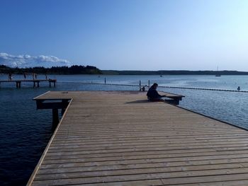 Scenic view of pier on lake against clear sky