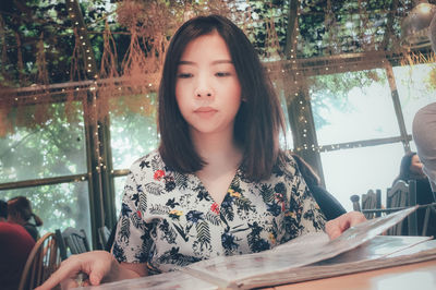 Woman sitting at table in cafe