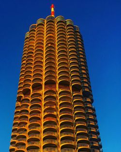 Low angle view of modern building against blue sky