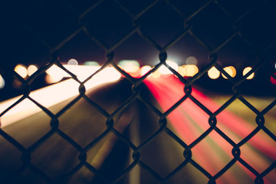 Close-up of chainlink fence against sky