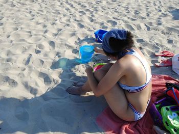 High angle view of boy sitting on beach