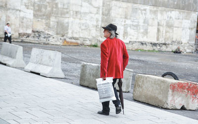 Full length of woman standing on railing