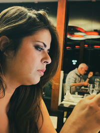 Close-up of young woman using mobile phone