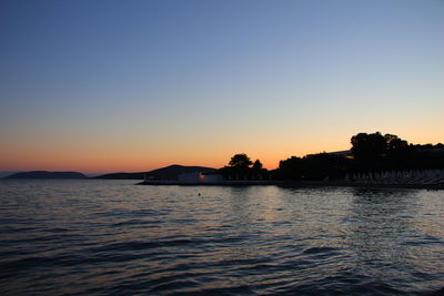 Scenic view of sea against clear sky during sunset