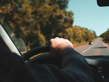 Midsection of man in car