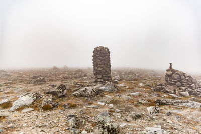 Castle on rocks against sky