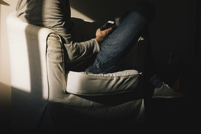 Low section of man sitting on seat