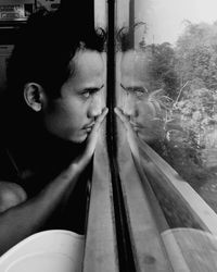 Portrait of man looking through train window