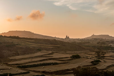 Scenic view of landscape against sky during sunset