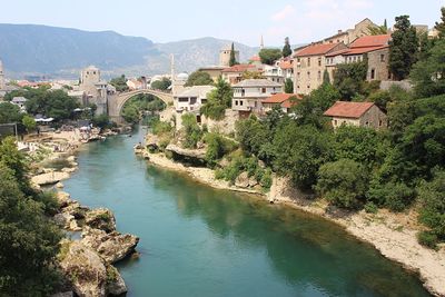 Scenic view of river amidst buildings in city