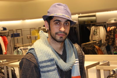 Portrait of young man standing in store