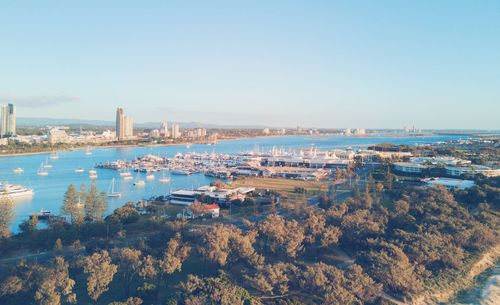 High angle view of buildings by sea against clear sky