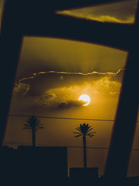 Low angle view of silhouette palm tree against sunset sky