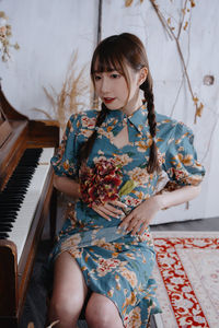 Portrait of young woman playing piano