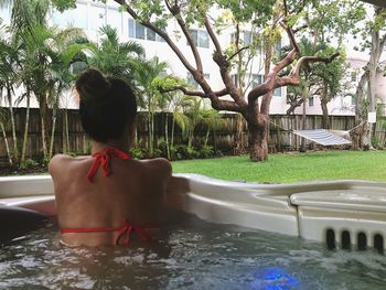 Rear view of woman in swimming pool 