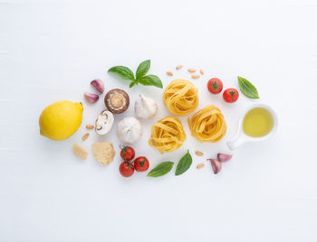 High angle view of fruits on table against white background