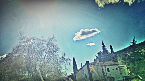 Low angle view of buildings and trees against sky