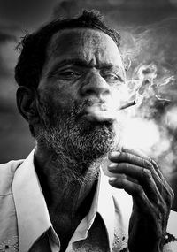 Portrait of man smoking cigarette outdoors