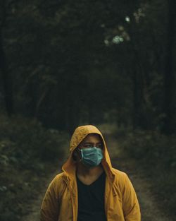 Portrait of man standing in forest