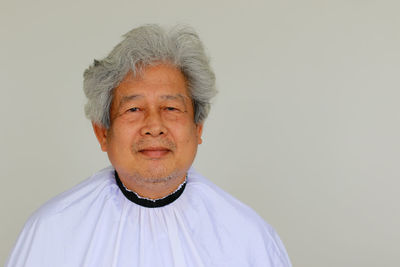 Portrait of smiling man against white background