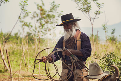 Man horse rope while standing outdoors