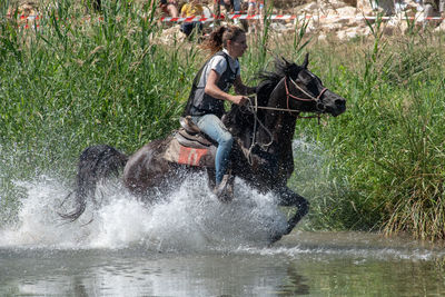 Man riding horse in water