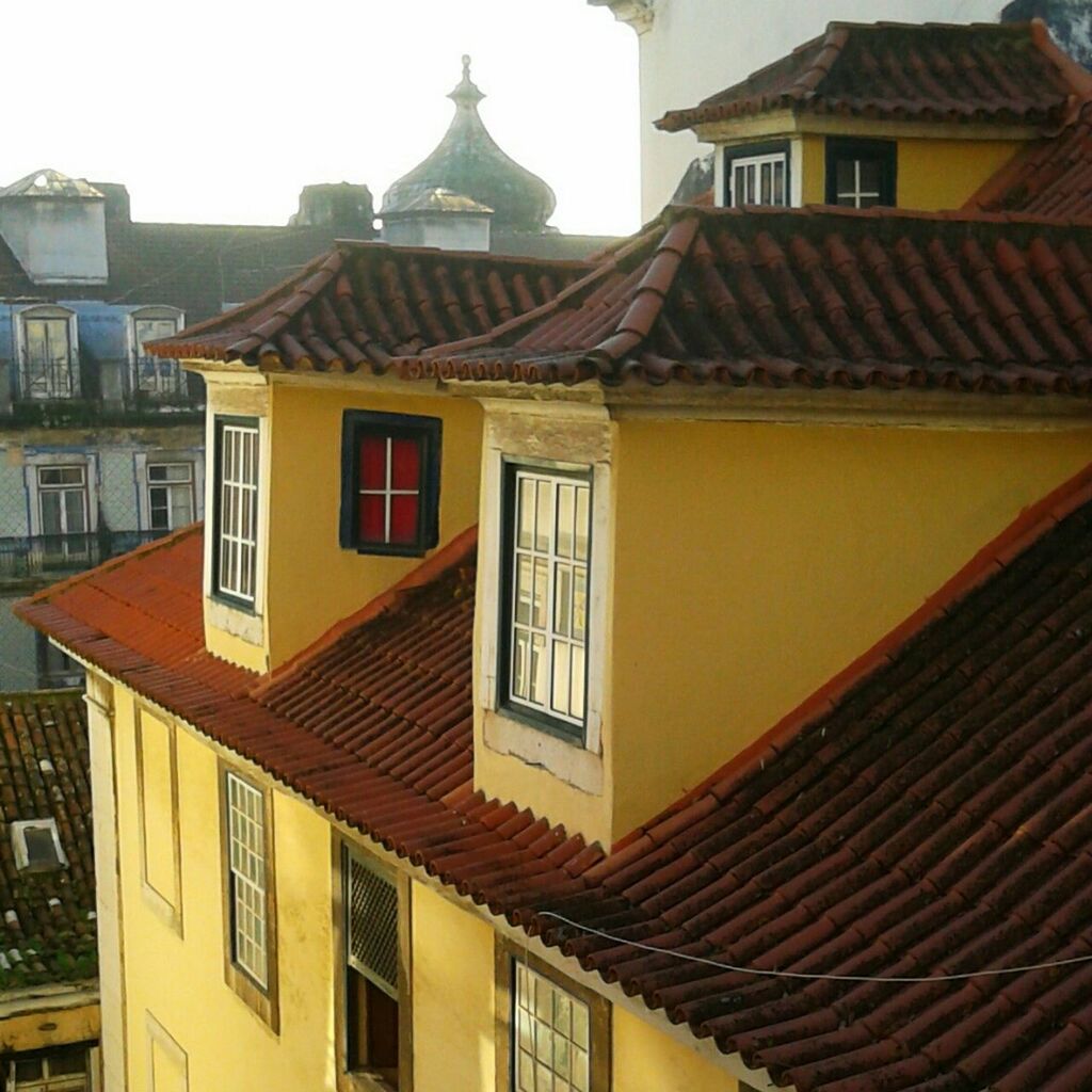 architecture, building exterior, built structure, roof, residential structure, house, window, residential building, low angle view, roof tile, balcony, exterior, building, facade, clear sky, outdoors, no people, sky, day, city