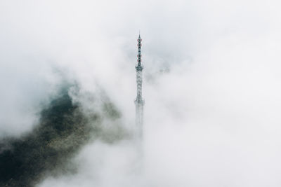 Low angle view of communications tower against sky