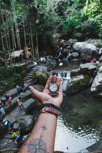 Midsection of woman with arms raised