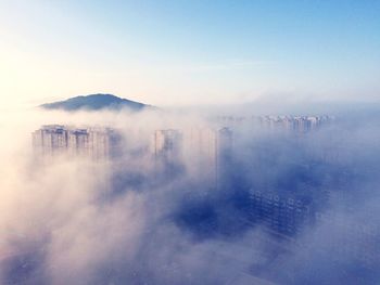 Aerial view of clouds covering city