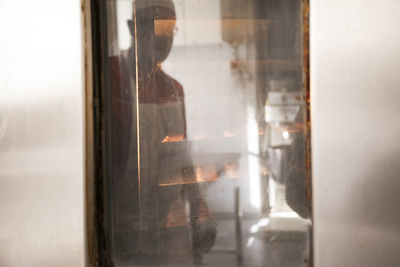 Reflection of man on door