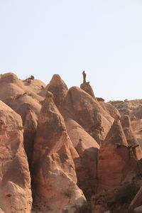 Rock formations on landscape against clear sky