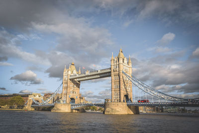 View of bridge over river against cloudy sky