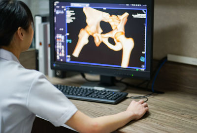 Midsection of woman using mobile phone