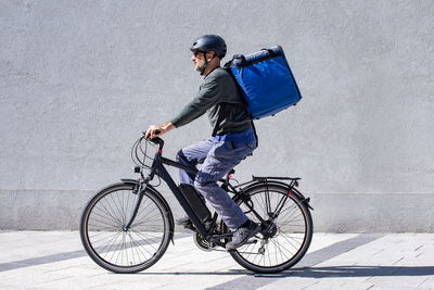 Deliveryman riding electric bicycle
