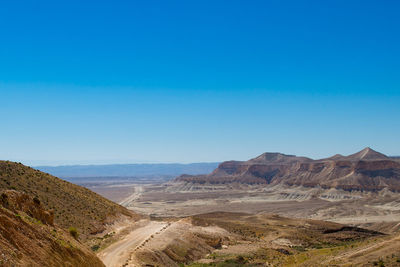 Scenic view of mountains against clear blue sky