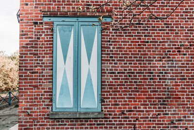 Window on brick wall of building