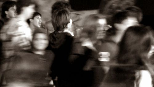 Blurred motion of woman walking on road