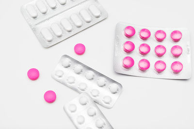 High angle view of pink petals on white background