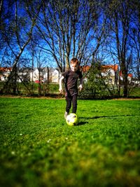 Man playing with ball on grassland
